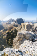Paragliding over Sassolungo, Sassopiatto and Sella Pass in autumn seen from Sass Pordoi, Dolomites, Trentino, Italy