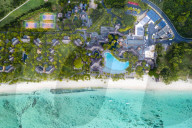 Luxury tourist resort on palm-fringed beach facing the tropical lagoon, Le Morne Brabant, Indian Ocean, Mauritius, (drone)