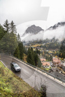 Car traveling on mountain road towards the village of Canazei in autumn, Dolomites, Val di Fassa, Trentino-Alto Adige, Italy