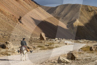 Man with his horse in the valley of Chehel Burj or forty towers fortress, Yaklawang province, Bamyan, Afghanistan