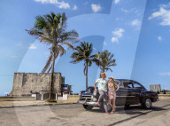 Cuban Couple with Vintage Chevrolet Car, Tower of la Chorrera in the background, Havana, La Habana Province, Cuba (MR)