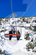 January 2020 Borovets Ski Resort, Bulgaria. A skier and Snowboarder sit on Markudjik ski lift