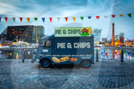 A Pie & Chips food van at the Albert Dock site on the River Mersey waterfront during the even twilight / blue hour.
