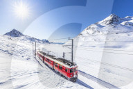 Bernina Express transit along Lago Bianco in winter , Bernina Pass, Engadin, Canton of Graubunden, Switzerland, Europe.