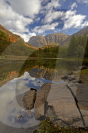 The rugged peak of Aonach Dubh reflected in Torren Lochan, Glencoe, Argyll and Bute, Scotland, United Kingdom, Europe