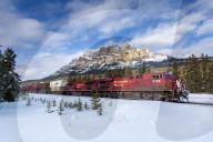 Canadian locomotive passing Castle Mountain in winter, near Banff, Alberta, Canada