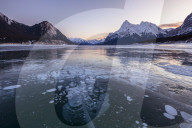 Snow capped mountains with methane bubbles at Lake Abraham, Alberta, Canada