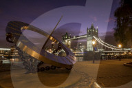 LON 73 Tower Bridge with the sundial statue at St Katherines Dock at night, London.