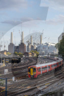 LON 87 Gatwick Express passenger train travelling towards London Victoria station with Battersea Power Station under construction, London