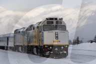 VIA Rail train with snow covered mountain backdrop Jasper, Canadian Rocky Mountains, Alberta, Canada