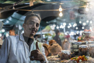 Market stall worker and chefs cooking, Djemaa El Fna Square, Marrakesh, Morocco