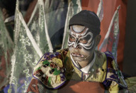 An actor waiting backstage before a performance of Vietnamese opera (hÃ¡t bá»™i)