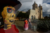 People participating in comparsas or street dances during the Day of The Dead Celebration.