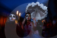 People participating in comparsas or street dances during the Day of The Dead Celebration.