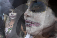 People participating in comparsas or street dances during the Day of The Dead Celebration.