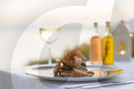 Prawns with white wine at sunset at a restaurant in Pefkos, Rhodes, Greece