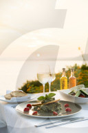 Food at a restaurant with a view over Pefkos Beach beach at sunset, Pefkos, Rhodes, Greece