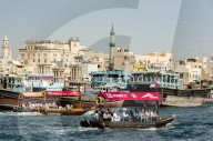 Abra water taxis passing dhows along Dubai Creek, Dubai, UAE