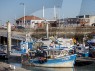 Port area of le Havre showing fishing boats and iconic twin chimneys