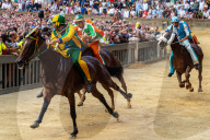 Jockeys in colourful outfits representing their respective neighbourhoods (contrade) vying for the lead at the Palio.