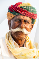 Distinguished senior horse trader with remarkable moustache and brightly multi-coloured turban, at the annual Chandrabhaga Fair