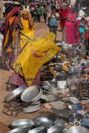 Rajasthani women in brightly coloured traditional clothing shopping for kitchen utensils, Pushkar Fair.