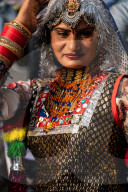 Dancer in brightly coloured traditional clothing in the inauguration procession for the Chandrabhaga Fair.
