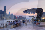 Skyline of Hong Kong Island and Tsim Sha Tsui promenade at sunset, Hong Kong