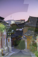 Traditional houses in Bukchon Hanok village and Namsan Seoul Tower at dusk, Seoul, South Korea