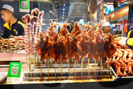 Fried squid on sticks and octupus tentacles in street market in Muslim quarter, Xi‚Äôan, Shaanxi, China