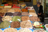 Uyghur Muslim stallholder selling locally grown and dried fruit and nuts, Kashgar, Xinjiang, China