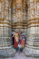 Family posing for photograph at the ornately carved Modhera Sun temple, built in 1026, Mehsana, Gujarat, India