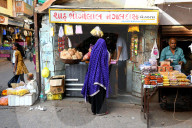 Hindu woman in purple dupatta shopping in the busy market, Bhuj, Gujarat, India