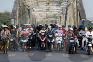 Scooters crossing the famous Trang Tien bridge in morning rush hour traffic. Hue. Vietnam.