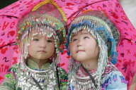 Monsoon or rainy season. Hmong children under umbrella. Sapa. Vietnam.