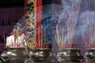 Taoist temple. Phuoc An Hoi Quan Pagoda. Incense sticks on joss stick pot are burning and smoke use for pay respect to Buddha