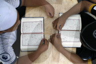 Muslim children learning Quran at Islamic school.