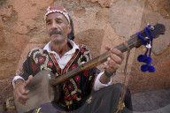 Gnawa musician sitting in a street in Marrakesh medina (old city), Morocco.