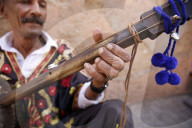 Gnawa musician sitting in a street in Marrakesh medina (old city), Morocco.