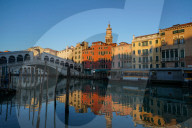 Reflections of the buildings and Rialto bridge in the Grand Canal during Coronavirus lockdown, Venice, Italy, Europe