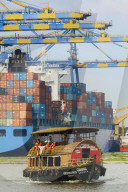 Tourist boat near container ship & cranes at Vallarpadam Container Terminal, a major Indian port; Kochi (Cochin), Kerala, India