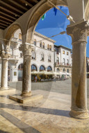 View of cafes from arches of the Town Hall in Forum Square, Pula, Istria County, Croatia, Adriatic, Europe