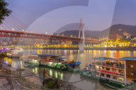 View of Masangxi Bridge and Yangtze River cruise boats at dusk in Chongqing, Yuzhong District, China, Asia