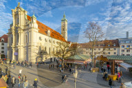 View of market and Heiliggeistkirche Church clock tower, Munich, Bavaria, Germany, Europe