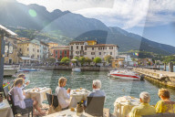 View of harbour and architecture on a sunny day, Malcesine, Lake Garda, Province of Verona, Italy, Europe