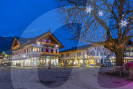 View of local shops in town at dusk, Garmisch-Partenkirchen, Bavaria, Germany