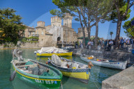 View of boats and Castello di Sirmione on a sunny day, Sirmione, Lake Garda, Province of Verona, Italy, Europe