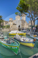 View of boats and Castello di Sirmione on a sunny day, Sirmione, Lake Garda, Province of Verona, Italy, Europe
