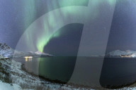 The northern lights or aurora borealis lighting up the sky near to Tromso, Norway.