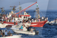 Chaotic scene at sea, as the Virgen del Carmen from Tarifa is taken on an annual ritual voyage with small boats in attendance